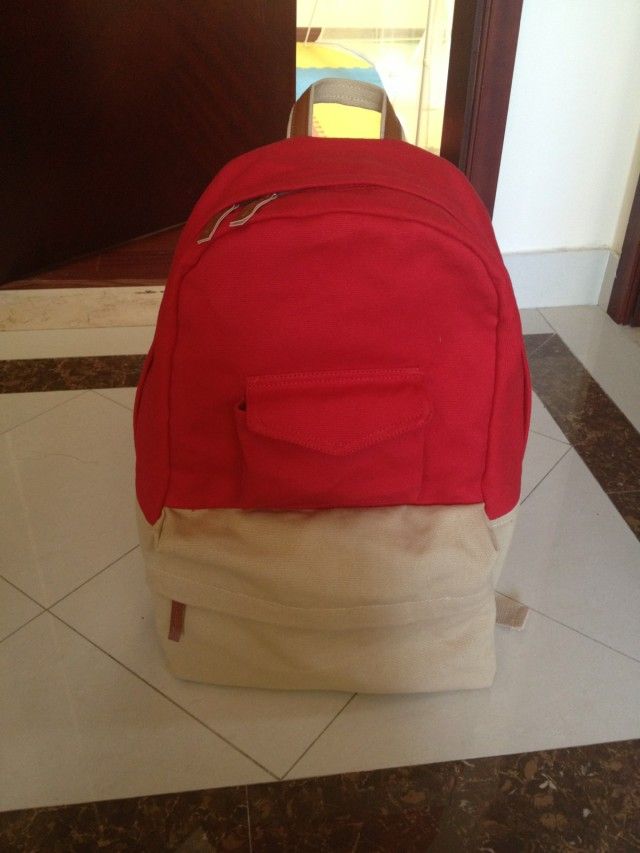 red color canvas backpack, school bag