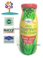 Aloe vera drink with white grape juice in an emerald green glass bottle