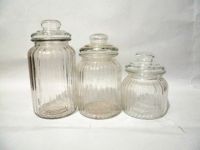Transparent glass canister bottle with vertical grain and glass lids
