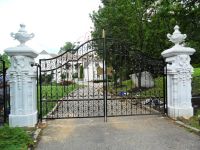 House driveway gate with stone pillars