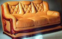 For Sale: Pure leather sofa with polished mahogany woods