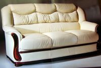 Pure white leather sofa with polished mahogany woods