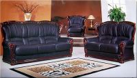 Black leather sofa with polished mahogany wood