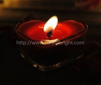 burning tealight candles in heart shape