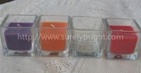 square glass candle in clear glass jar