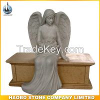American style angel sitting on yellow marble bench