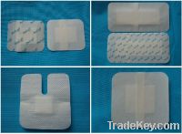 Non-woven adhesive dressing