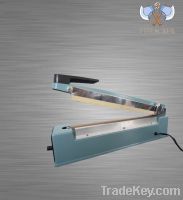 Hand impulse sealing machine with side cutter