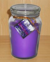 purple scented wax candle in clear glass container