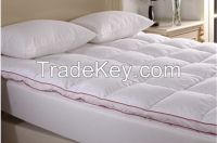 Hollow fibre or polyester wadding filled mattress topper