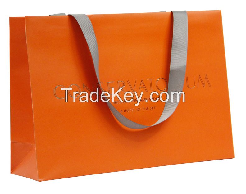 Handmade coloured paper carrier bags with ribbon handles