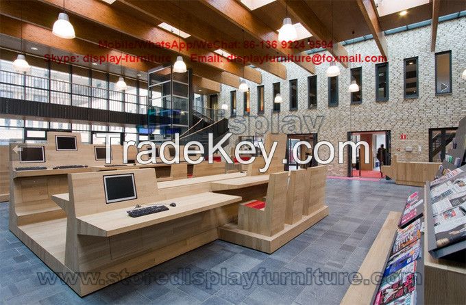 Centre library Furniture design by oak wood counters and bookcase shelves with fabric bench