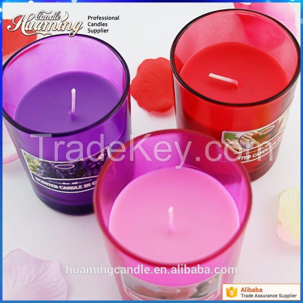 scented candles in colored glass jar