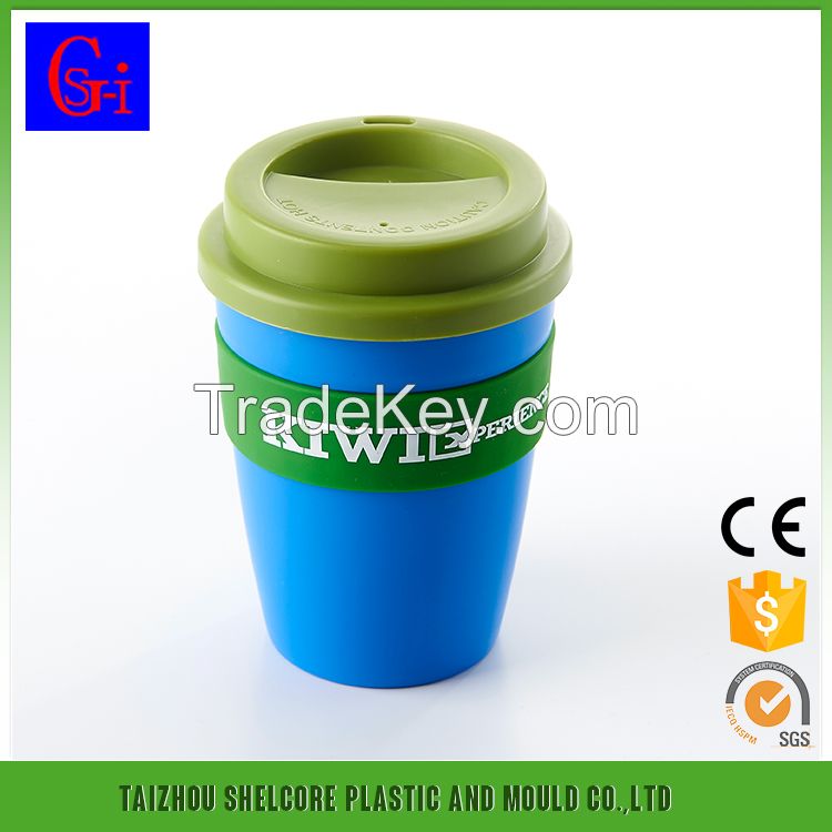 Plastic coffee cup with lid and silicone sleeve