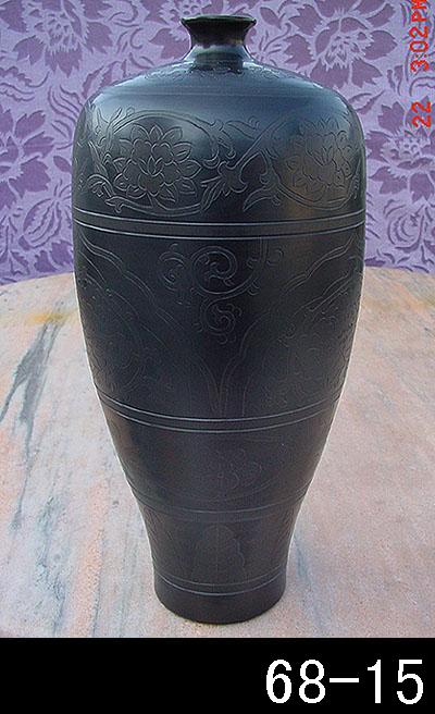 black pottery vase plum