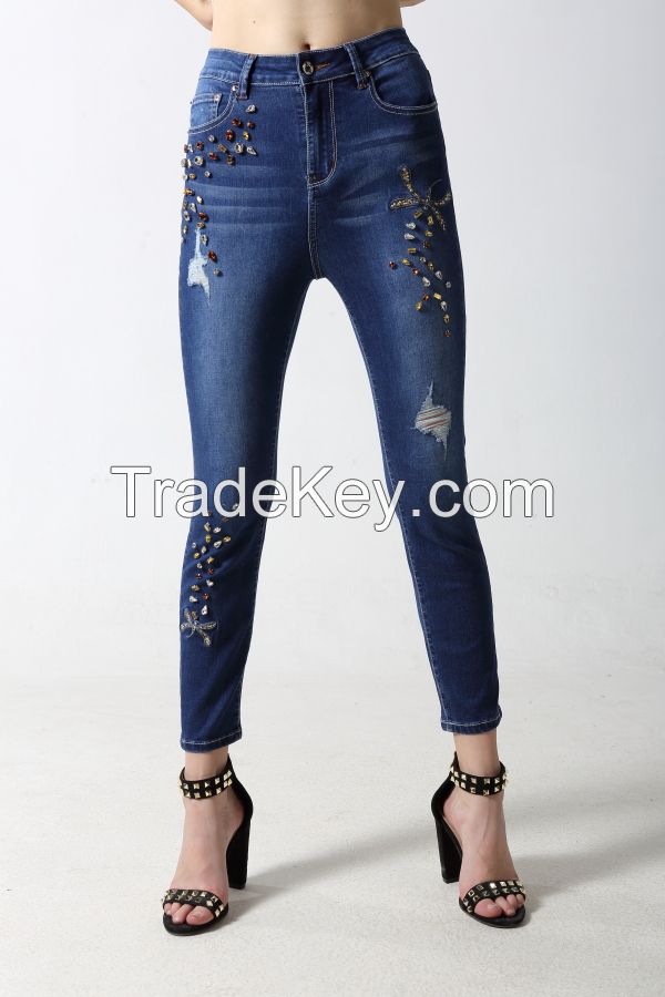 Woman's slim denim jeans with embroidery and sparkling