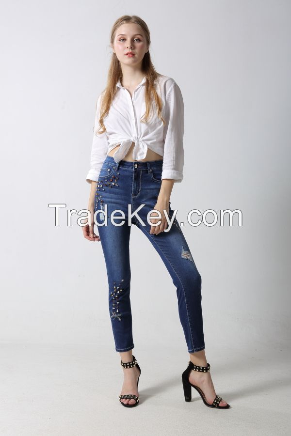 Woman's slim denim jeans with embroidery and sparkling