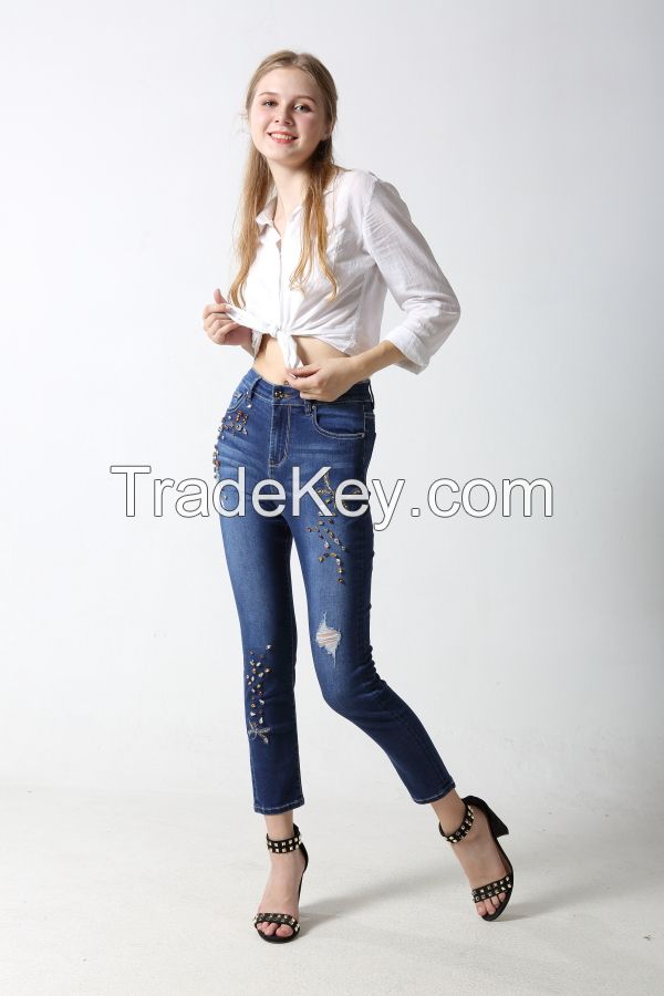 Woman's slim denim jeans with embroidery and sparkling