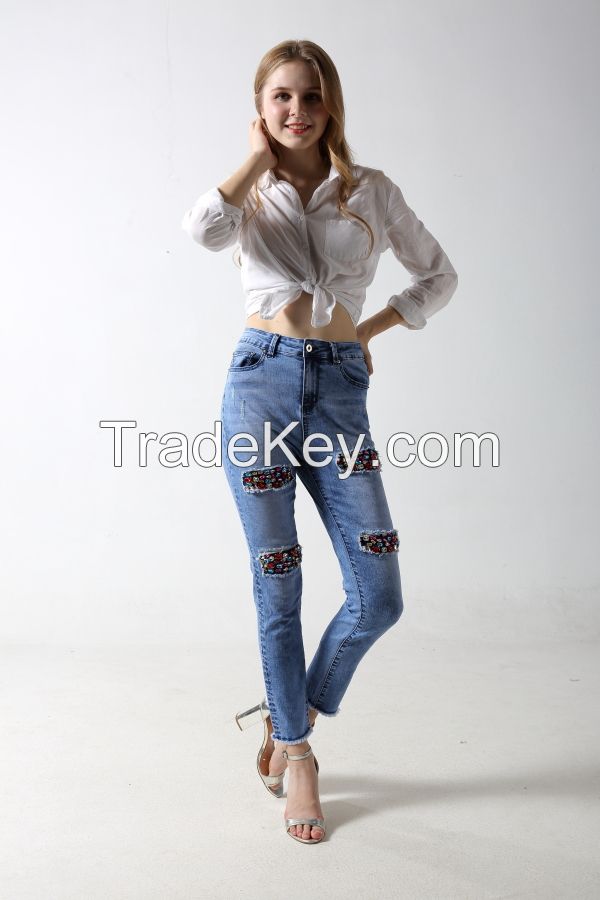 Woman's denim jeans with distressed and patches with sparkling