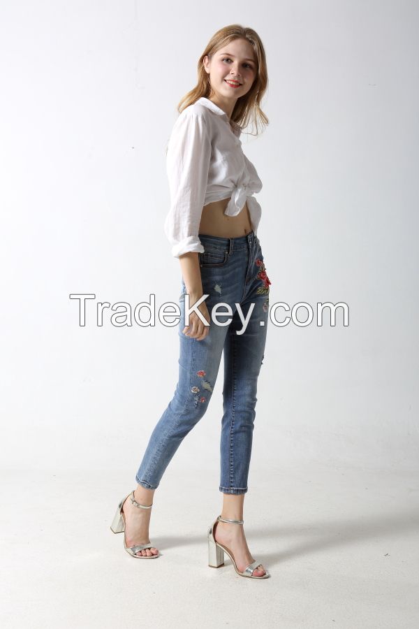 Woman's slim denim jeans with embroidery and sparkling