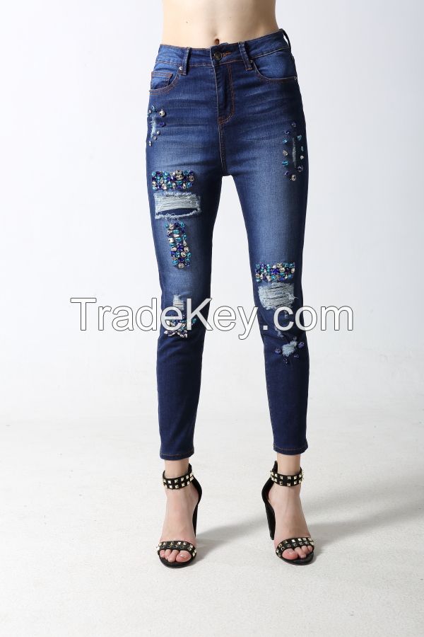 Woman's slim denim jeans with distressed and sparkling