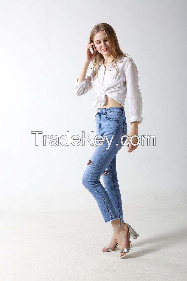 Woman's denim jeans with distressed and patches with sparkling