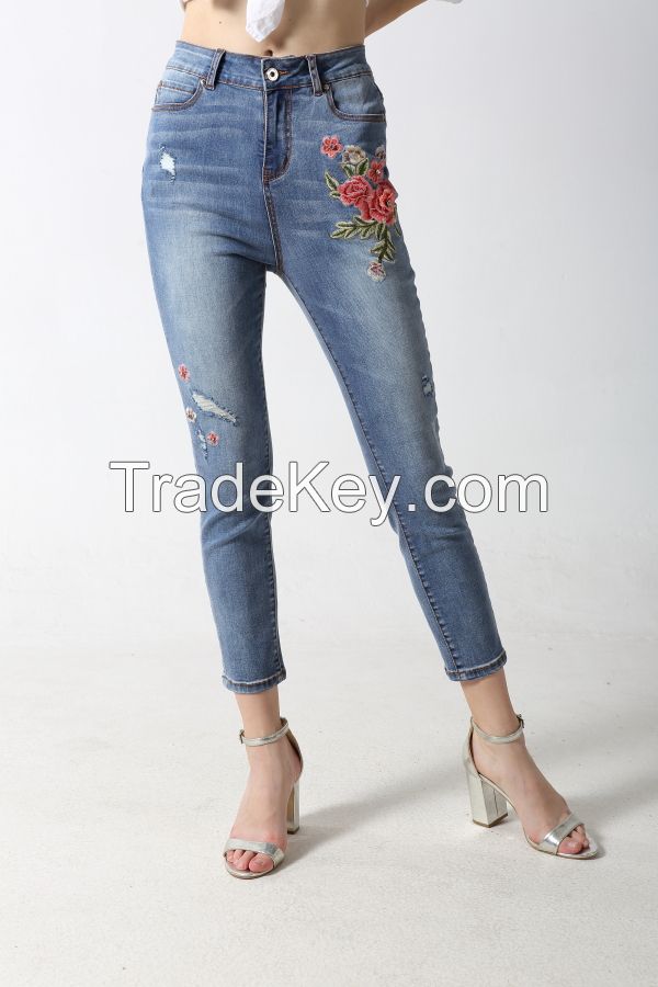 Woman's slim denim jeans with embroidery and sparkling