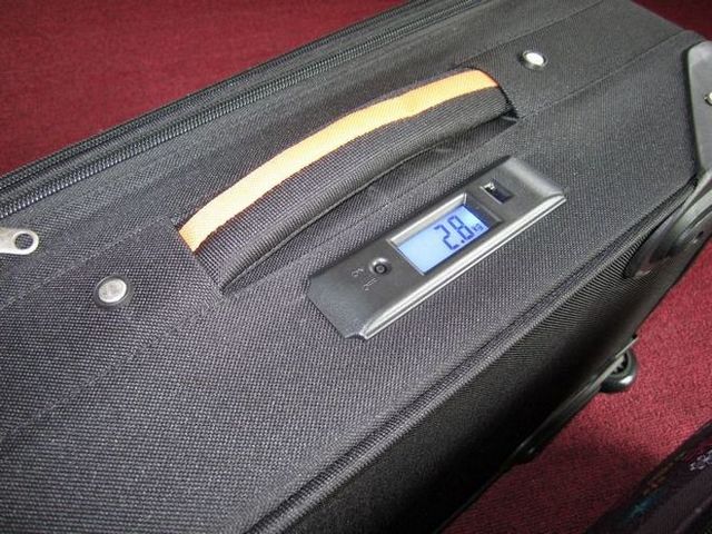 Suitcase with weighing mechanism