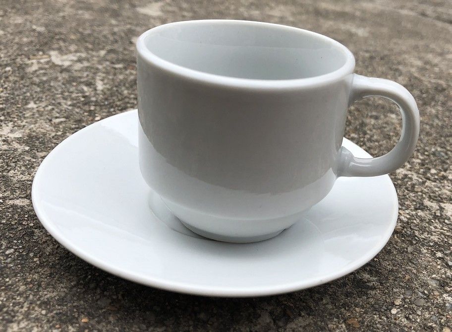 Ceramic white coffee cup and saucer with golden box packing 