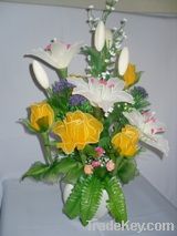 Arrangement of artificial flowers, yellow roses and white lilies