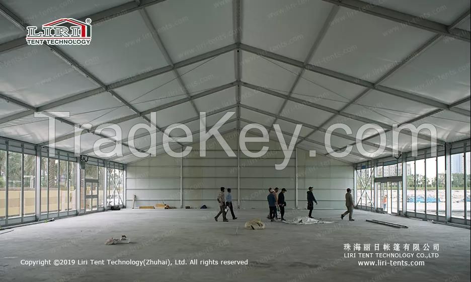 alluminum frame clear span tent with glass sidewalls and sandwich panel