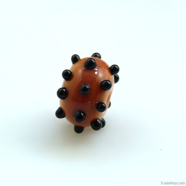 lampwork glass amber bead with black dots