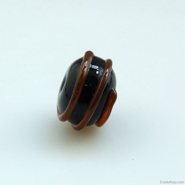 lampwork glass black bead with amber swirl
