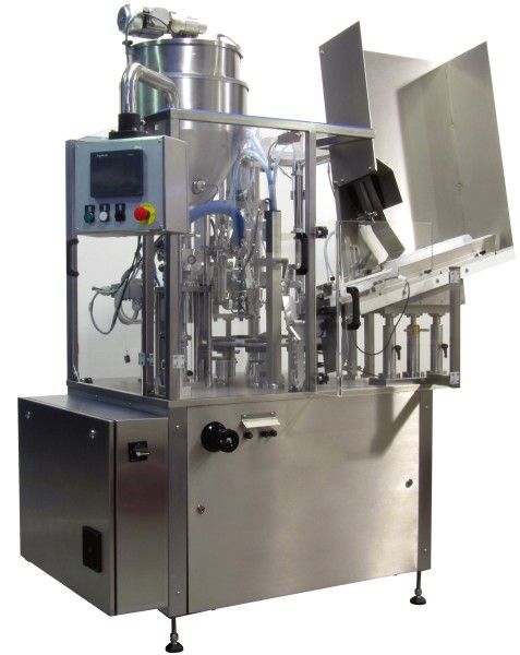 Tube filling and closing machine