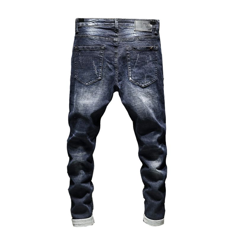 Mans fashionable ripped denim pants with patch