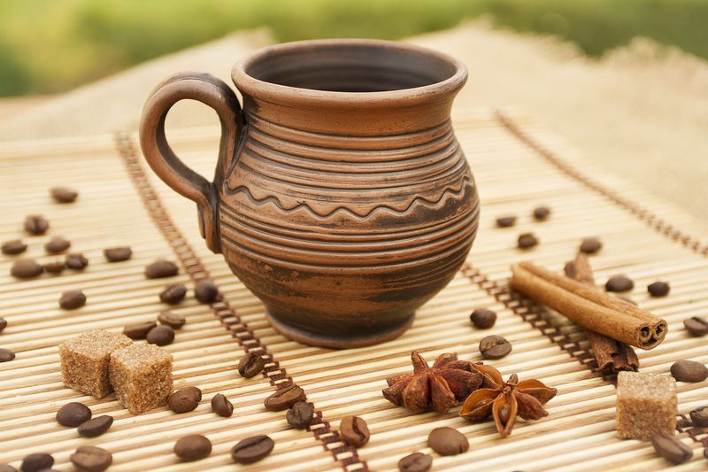 Handmade decorative coffee mug made of red clay.