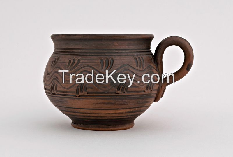 Ceramic tea cup, hand formed and made out of red clay. 