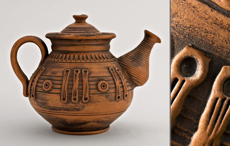 Handmade ceramic tea pot made of red clay.