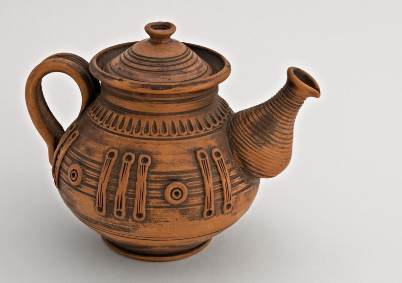 Handmade ceramic tea pot made of red clay.