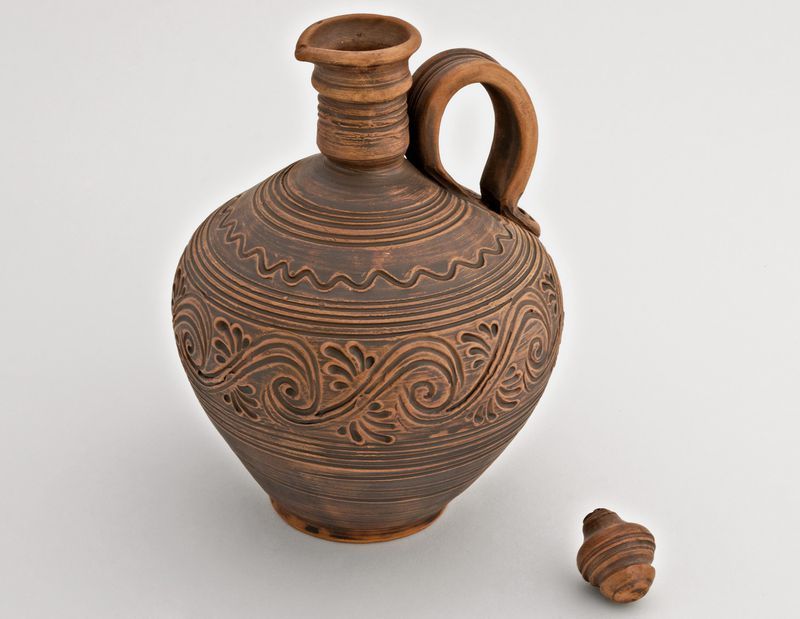 Clay jug with lid.