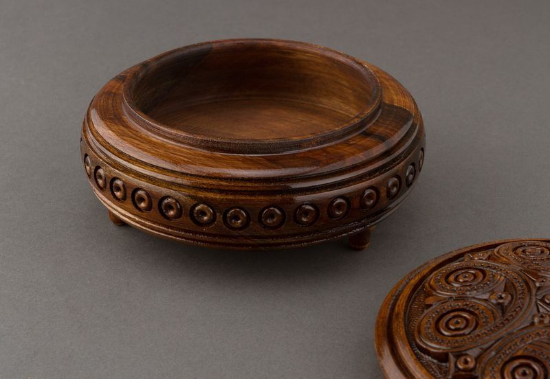 Handmade round wooden jewelry brown box with carving.