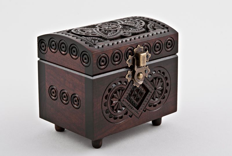 Wooden jewelry box with hand carved pattern.