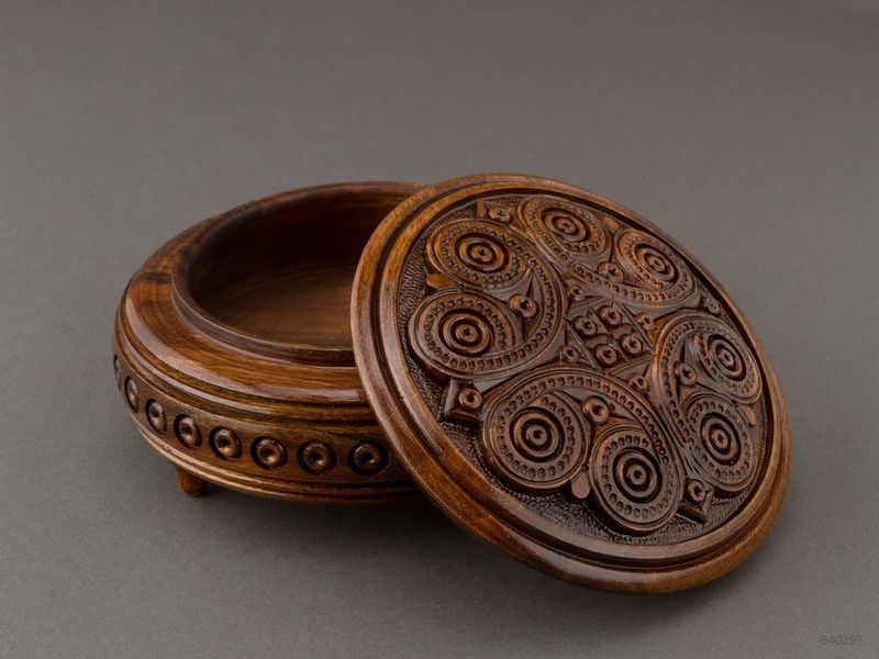 Handmade round wooden jewelry brown box with carving.