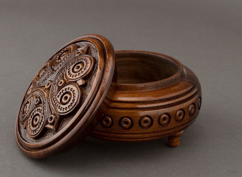 Round hand carved brown jewelry box.