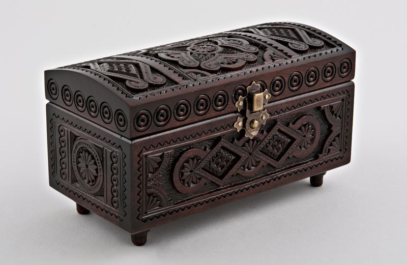 Wooden jewelry box with hand carved pattern.