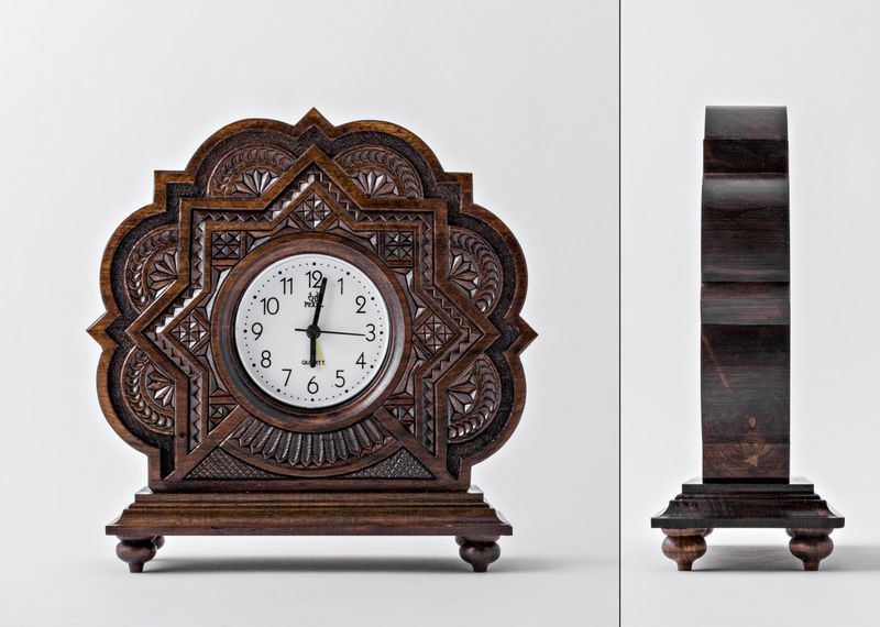 Wooden alarm clock with hand carved pattern.