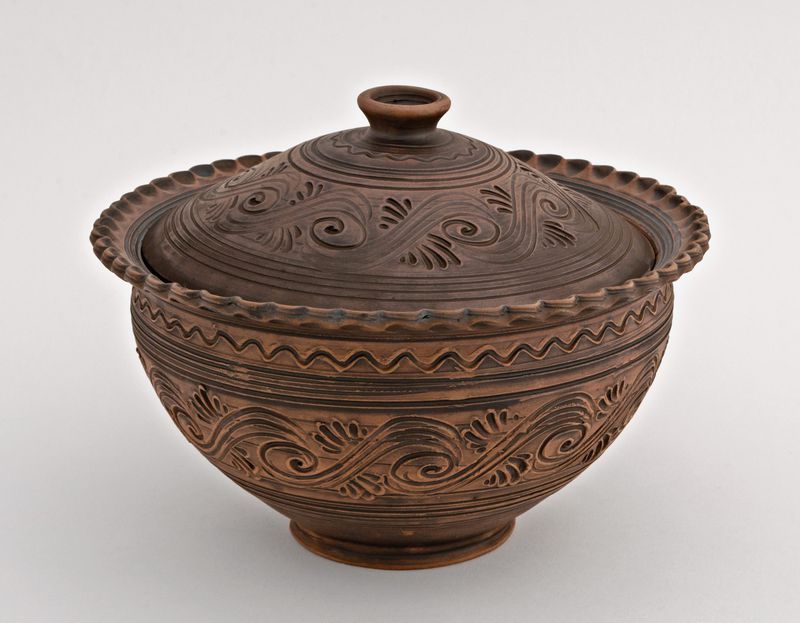Ceramic brown bowl with lid made of red clay by hand.