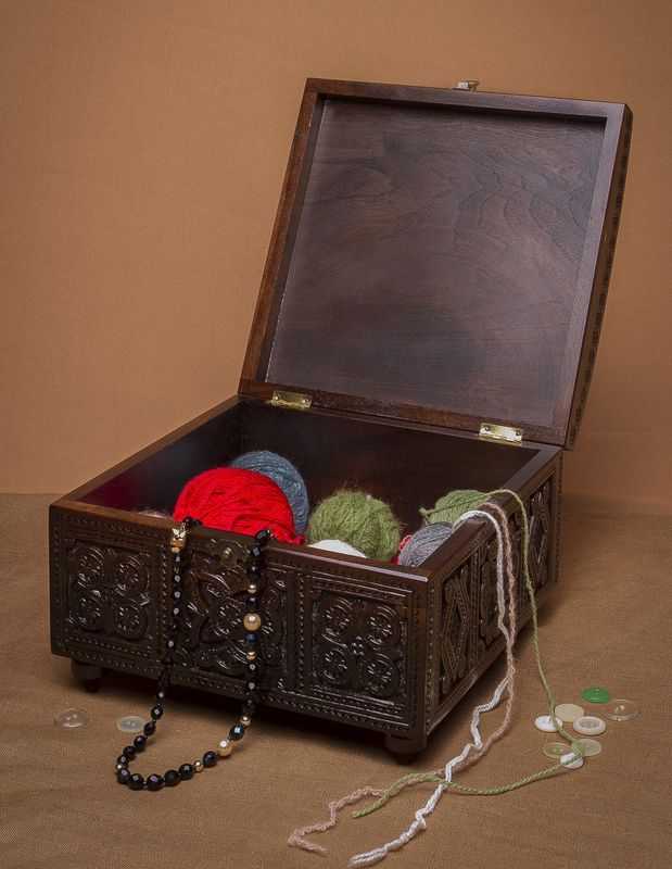 Wooden rectangular jewelry box with hand carved pattern.