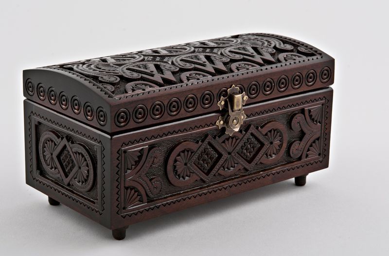 Wooden rectangular jewelry box with hand carved pattern.