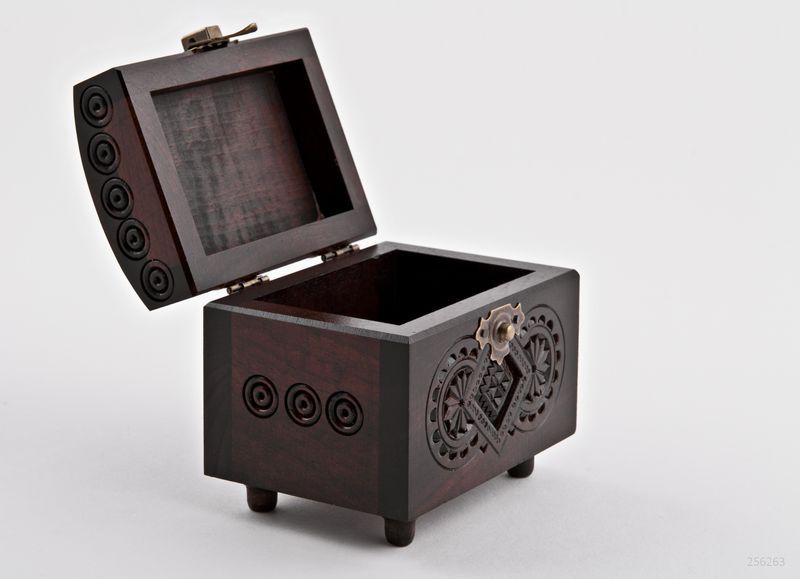 Wooden jewelry box with hand carved pattern.